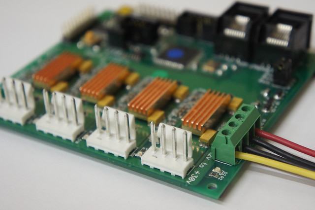 Early green TinyG board with four heatsinked stepper drivers and screw-terminal power input